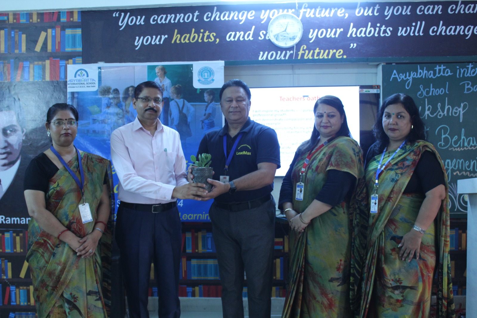 LeadmaxEdge facilitator receiving a plant during a school workshop